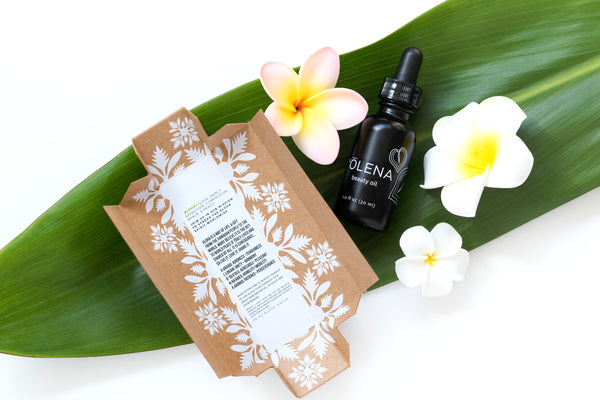 Picture of Honua Hawaiian Skincare Olena (Turmeric) beauty oil and open box containing the words and spirit of Aloha
